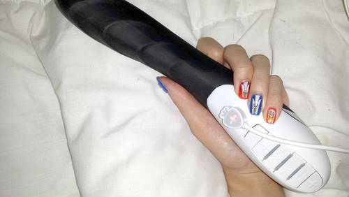 [Image: holding the mystim sizzling simon electrosex vibrator in my hand and showing off my angel nail decals]
