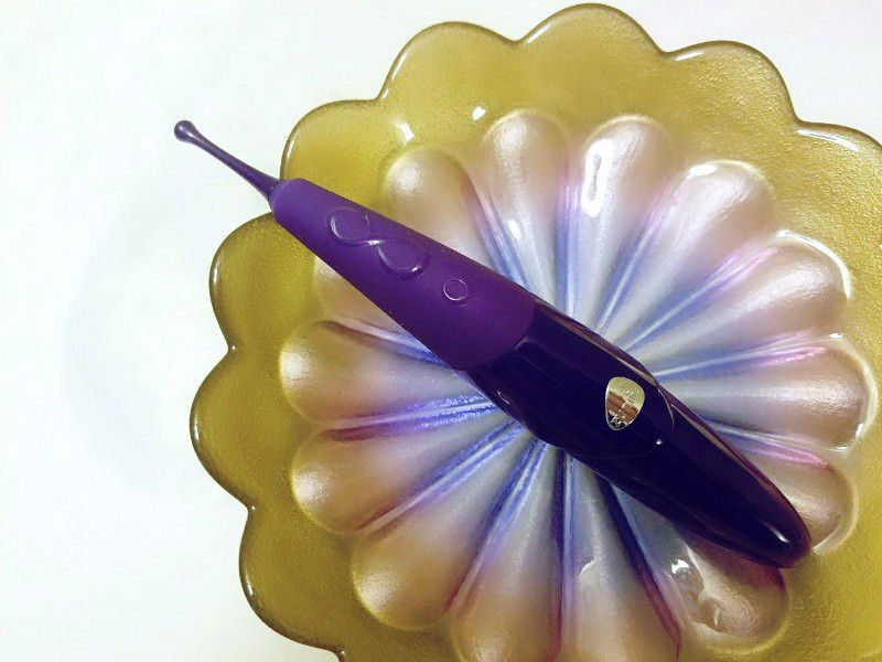 Zumio oscillating vibrator in a purple and gold flower petal plate