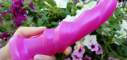 The Tantus Tsunami is a dildo with a curved tip and 3 ridges down the shaft.
