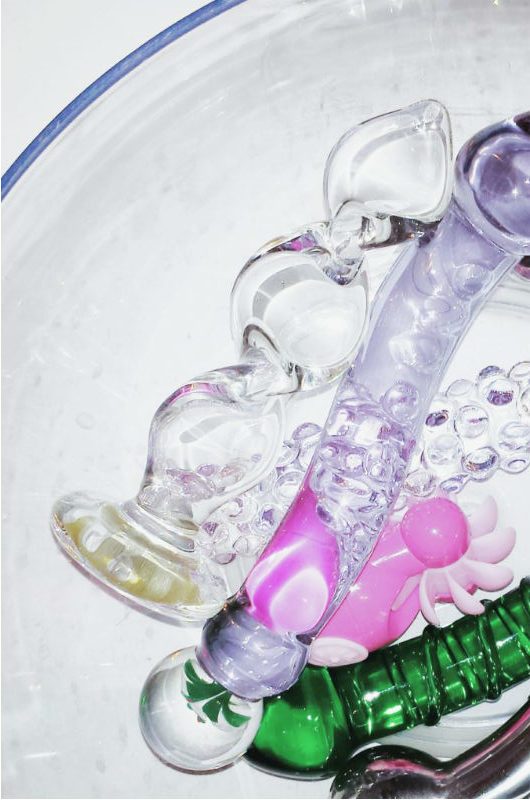 [Image: Crystal Delights Crystal Twist glass dildo next to my old toys in a bowl. This photo was from 2015!!!)