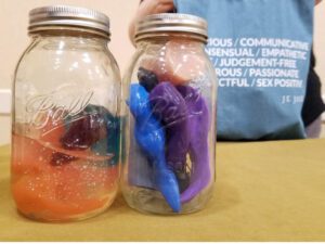 Jar on the left: toxic jelly sex toys melted over time. Jar on right: silicone sex toys, totally inert and no yucky stuff happening.