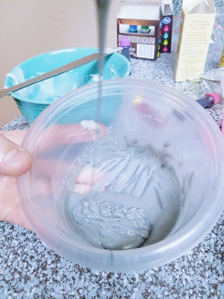 Drizzling ribbons of gray sugar cookie icing back into the bowl