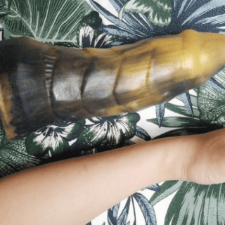 Frisky Beast Cybersaur huge dildo next to arm