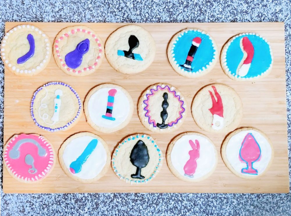 14 sex toy cookies on a cutting board