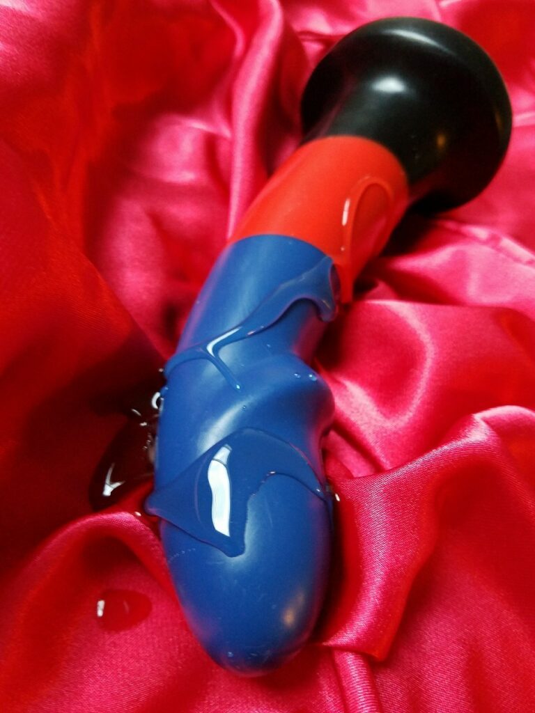 BS Atelier Max Poly Pride striped silicone dildo with lube on it