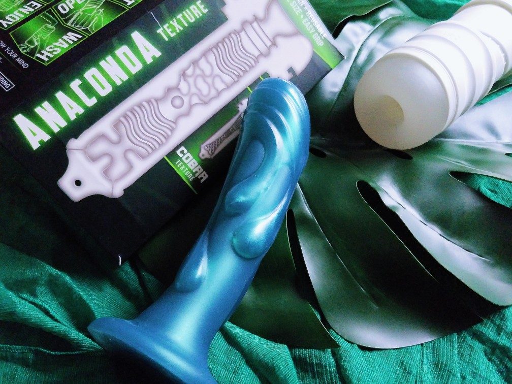 Picture of Zolo Twist Anaconda stroker/masturbation cup next to packaging and Tantus Splash