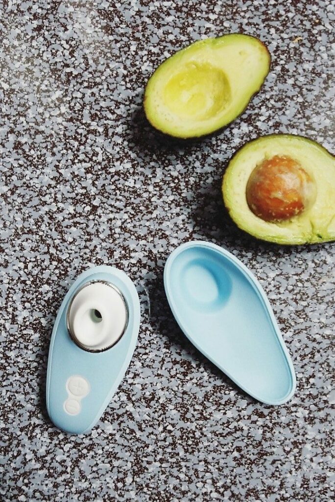 Womanizer Liberty travel case and size comparison to avocados