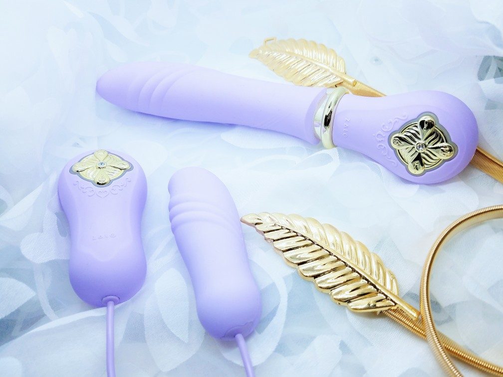 [Image: Zalo Sweet Magic Desire self-thrusting dildo and Temptation thrusting bullet in purple with gold accents]