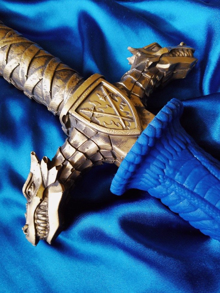 [Image: a close-up of the Drago sword dildo hilt and the dragons on either side.]