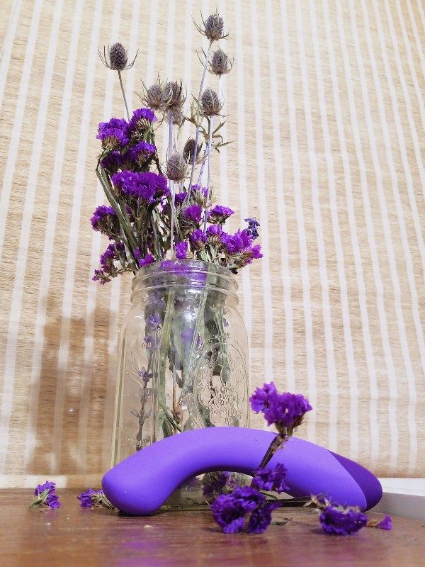 [Image: purple Blush Novelties Wellness G Ball G-spot vibrator in front of jar of dried purple flowers]