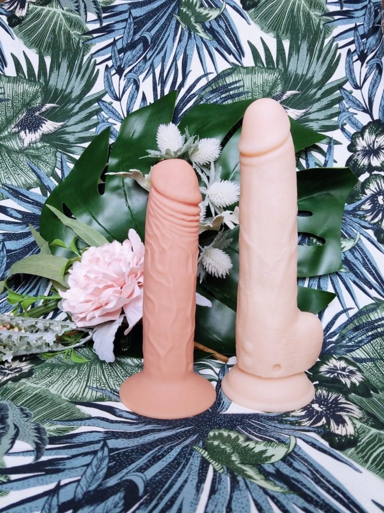 [Image: XR Brands Thump It 7.25" self-thrusting dildo next to BMS Naked Addiction 9" / 6.75" insertable dual-density in Vanilla] 