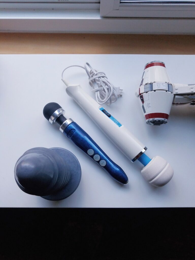 [Image: top view of silver Split Peaches Screw You Large, blue Doxy 3 Rechargeable, and Magic Wand Original massager with cord]
