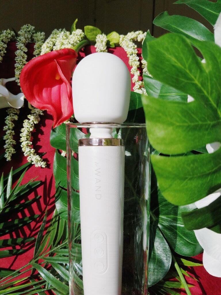 [Image: pearl white Le Wand Rechargeable body massager with rose gold accents]