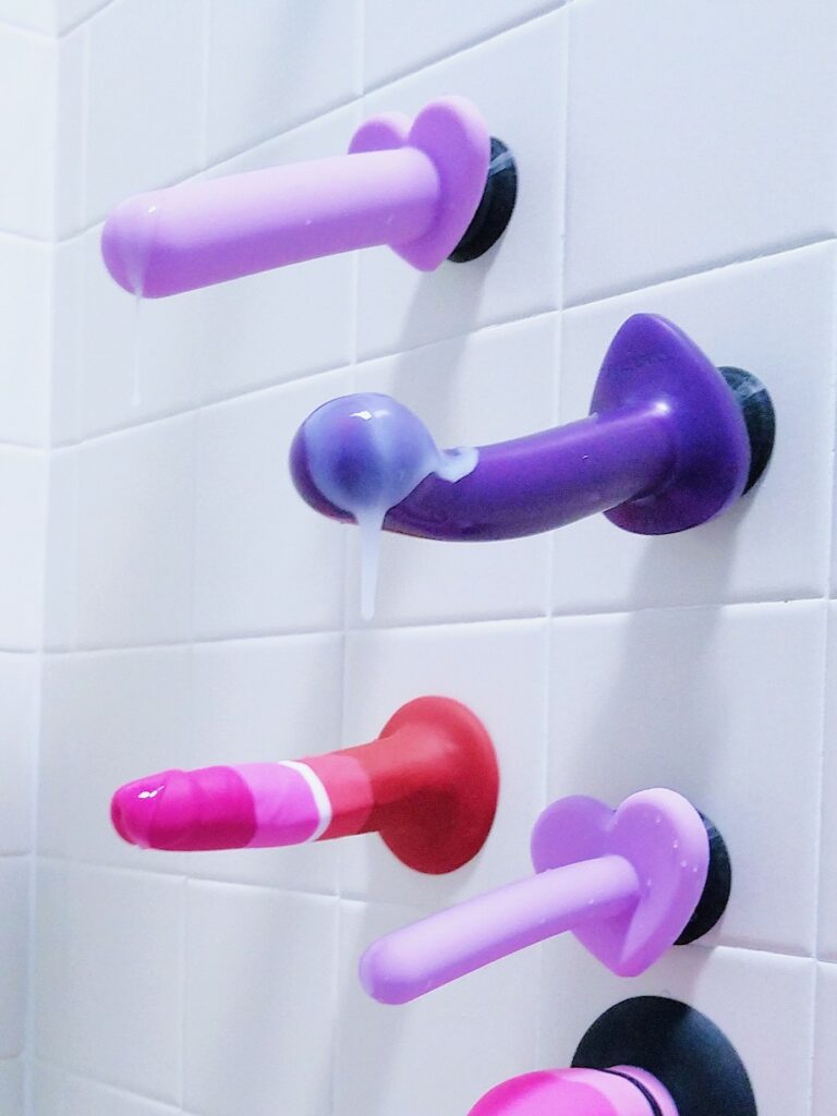 Silicone suction cup dildos and flat-based harnessable dildos with double-sided suction cups