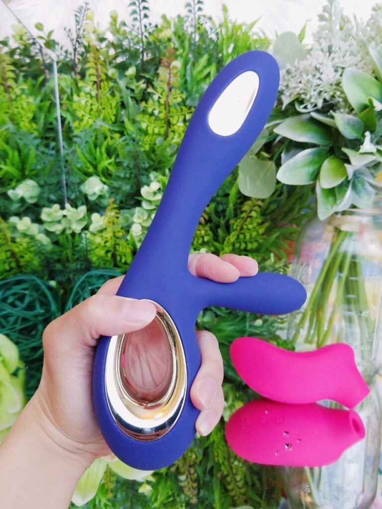 [Image: blue LELO Soraya Wave in hand with the clitoral stimulator flexed]