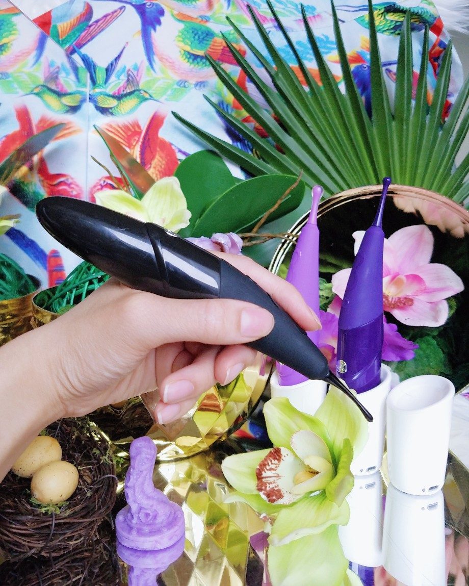[Image: holding the black Zumio E in my hand, like a paintbrush. Behind it are the lavender Zumio S Caress and eggplant purple Zumio X Classic]