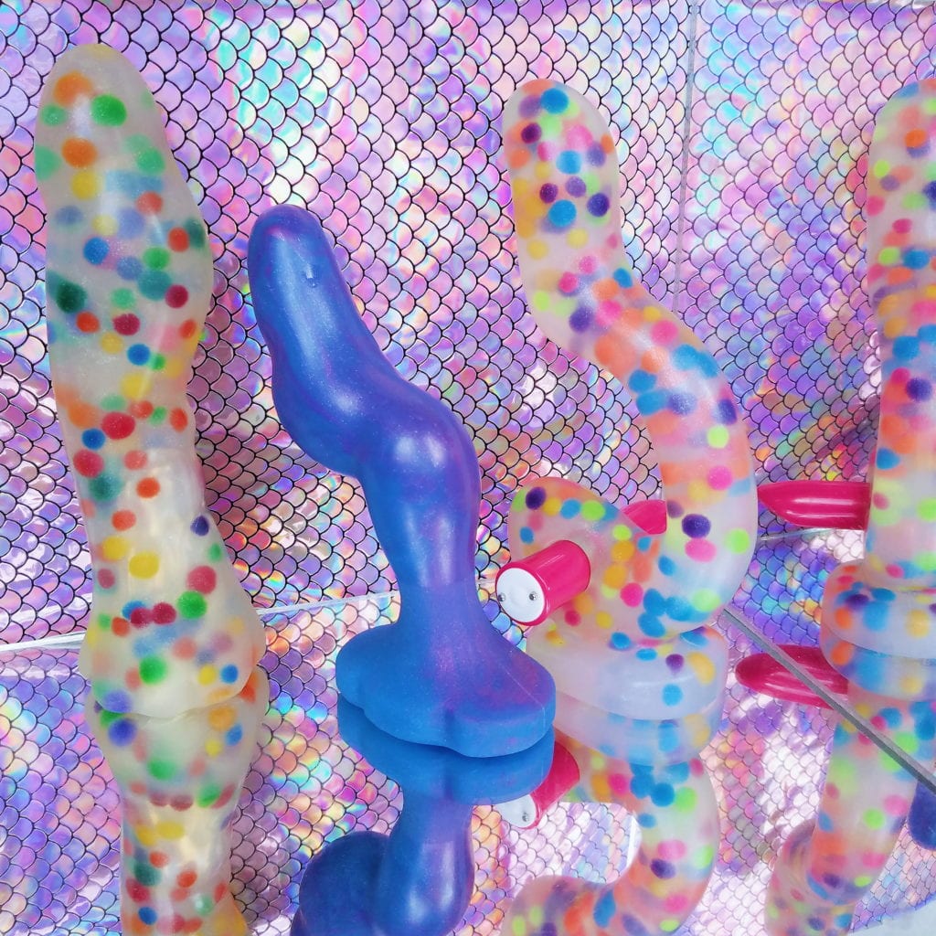 Polka dot LuzArte Jollet clear silicone dildo, Luna purple swirl, and Thrust with We-Vibe Tango