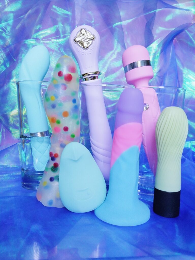 Dildos and vibrators in front of holographic background