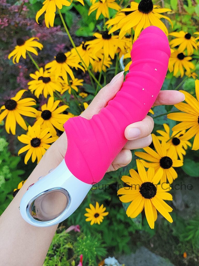 Holding the Fun Factory Tiger G5 G-spot vibrator to show its girth relative to my wrist. It's 1.6" wide at maximum diameter; a little thicker than the average human penis.