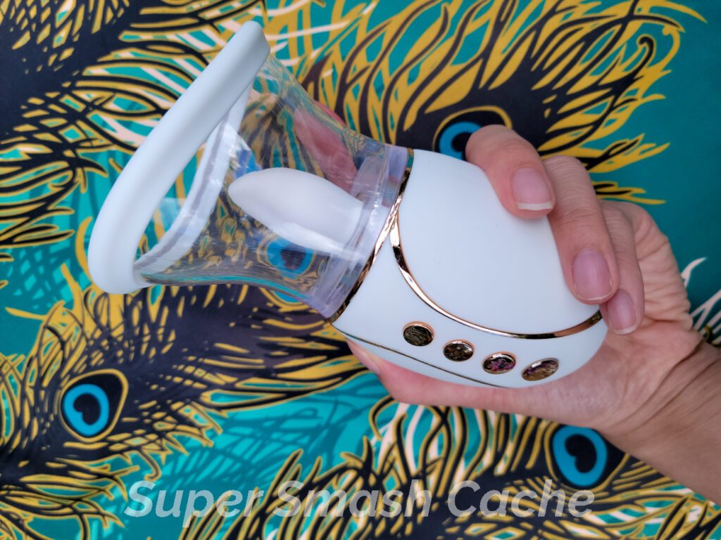 Holding the Cal Exotics Empowered Smart Pleasure Queen licking suction pussy pump vibrator in my hand