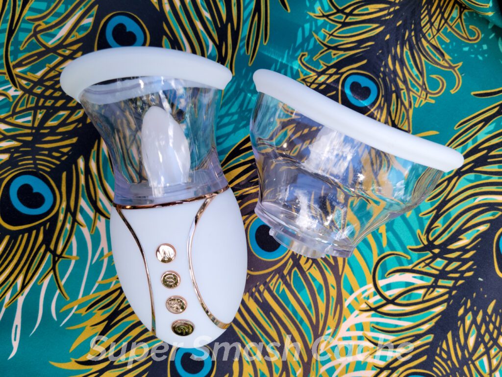 The California Exotics Empowered Smart Pleasure Queen tongue-flicking suction vibrator comes with two attachment heads, both with contoured oval openings that fit over the vulva