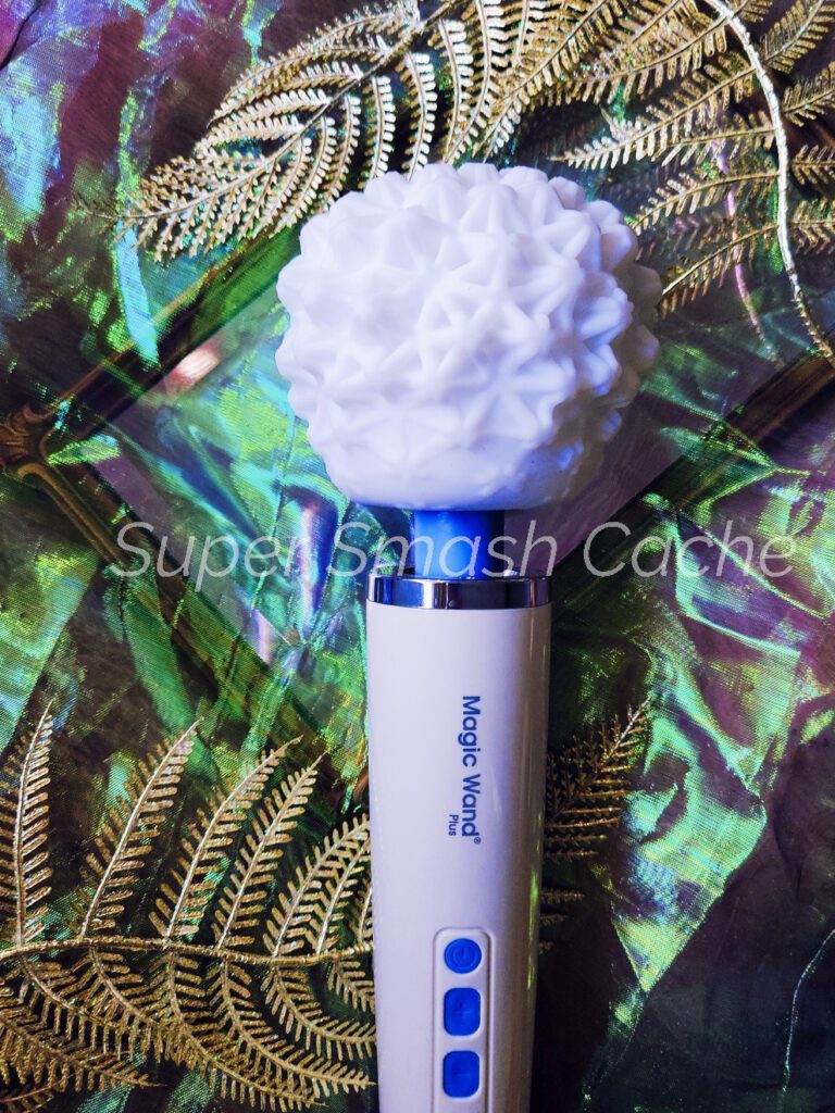 Tenga Geo Coral stroker inverted and placed on the Magic Wand Plus massager's head as a Magic Wand topper