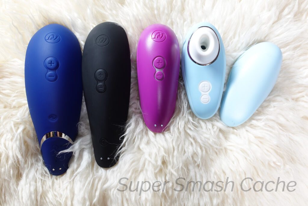 Womanizer Premium 2 vs. Classic 2 vs. Starlet 3 vs. Liberty size and control panel comparison. The Womanizer Premium 2 is the longest, while the Liberty is the smallest and comes with a hygienic travel cover.