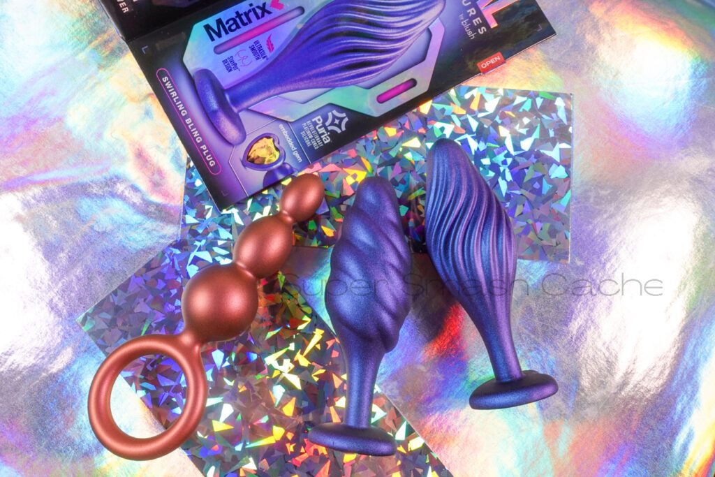 Left to right: the Blush Anal Adventures Matrix Beaded plug features three beads that increase in size. The Bumped plug shows nodes that slightly wrap around the bulb on a diagonal. The Swirled plug features, well, swirls across the bulb.