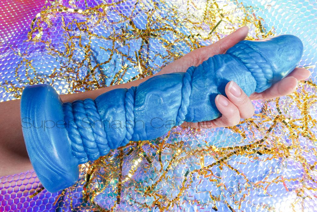 Uberrime Bound 2.0 XL Mermaid Blue big rope-themed dildo size comparison to arm. 