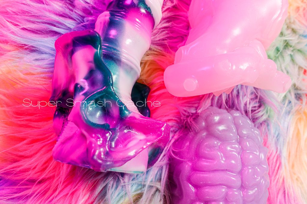 Velvet Alley Brainzzz grinder in glow-in-the-dark purple, Craven vertebral dildo, and anatomical heart silicone clitoral massager in ghost heart and glow pink