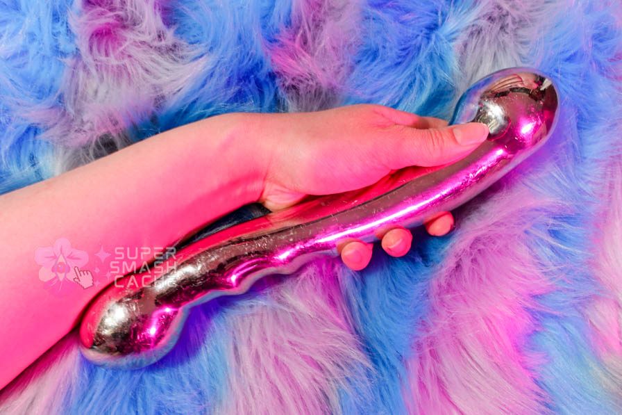 njoy Eleven 2.75 lb stainless steel dildo review 1 Holding the njoy Eleven stainless steel dildo in my hand for a size comparison to my wrist.