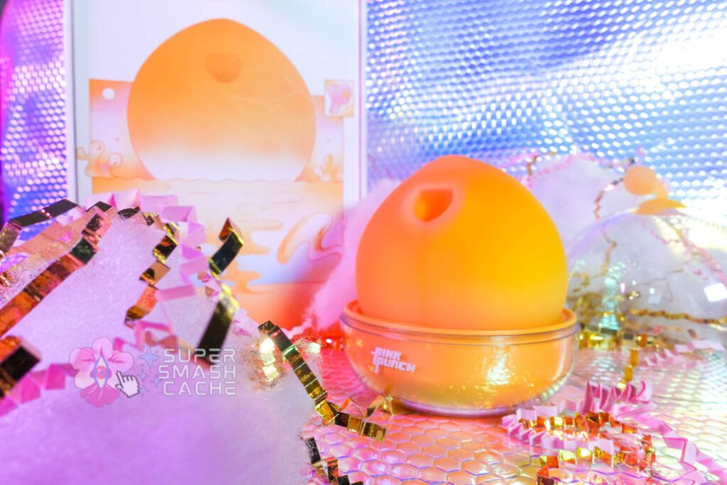 Pink Punch Peachu in charging dock next to packaging