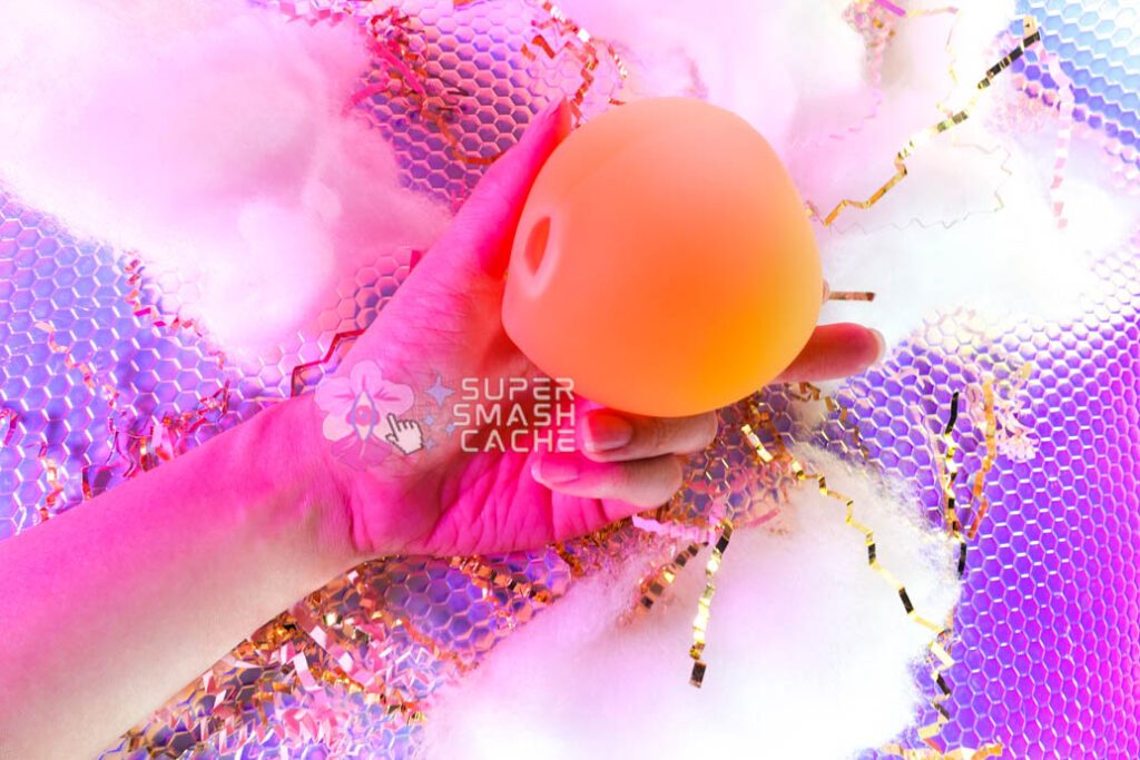 Pink Punch Peachu Peach-Shaped Air Pulse Massager in Hand