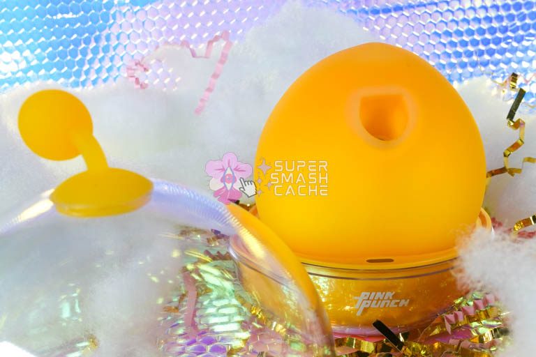 Pink Punch Peach Clitoral Suction Massager In Charging Dock Next to Case Cover