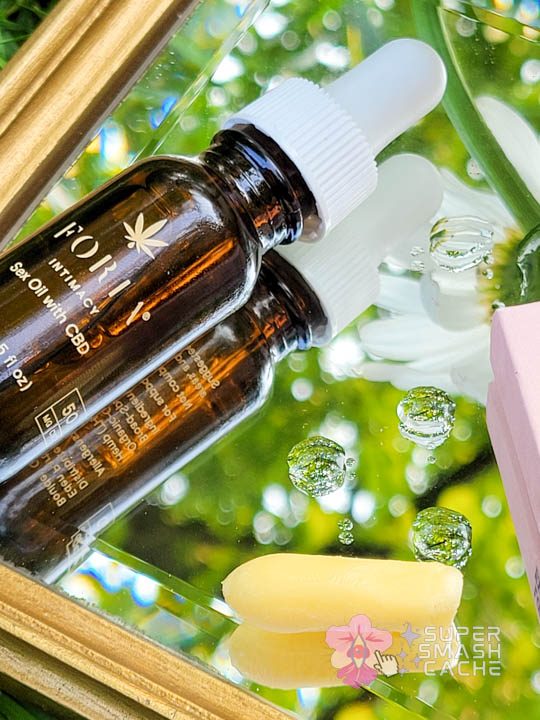 Foria Intimacy Sex Oil and Booty Melts suppository on mirror