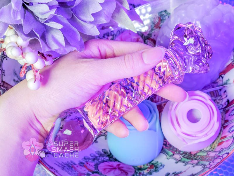 Pink glass dildo with rose-shaped base and textured shaft