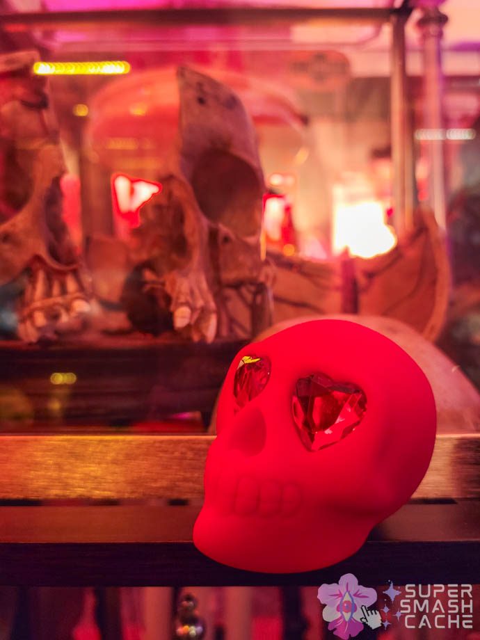 Mini-Reviews: Maia Shroomie & Naughty Bits Bone Head Skull Vibrator 9 Naughty Bits Bone Head skull-shaped vibrator by Cal Exotics next to an actual human skull in a glass display case