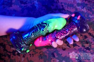 Uberrime Damn Alien dildos in UV green, UV pink, and glitter black with tightly marbled silicone