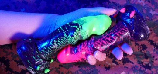 Uberrime Damn Alien dildos in UV green, UV pink, and glitter black with tightly marbled silicone