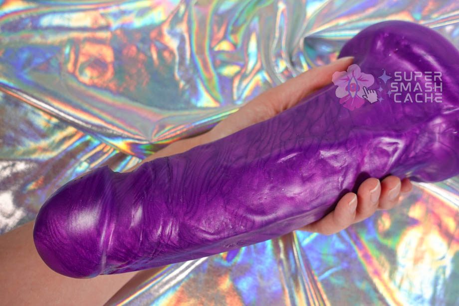 Uberrime Uberron giant glossy dildo in hand