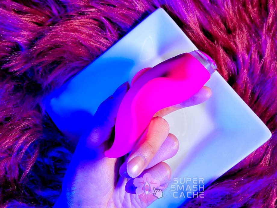 A hand holding a pink Clandestine Devices Mimic+ Plus vibrator 4