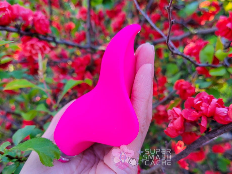 A hand holding a pink Clandestine Devices Mimic+ Plus vibrator 1
