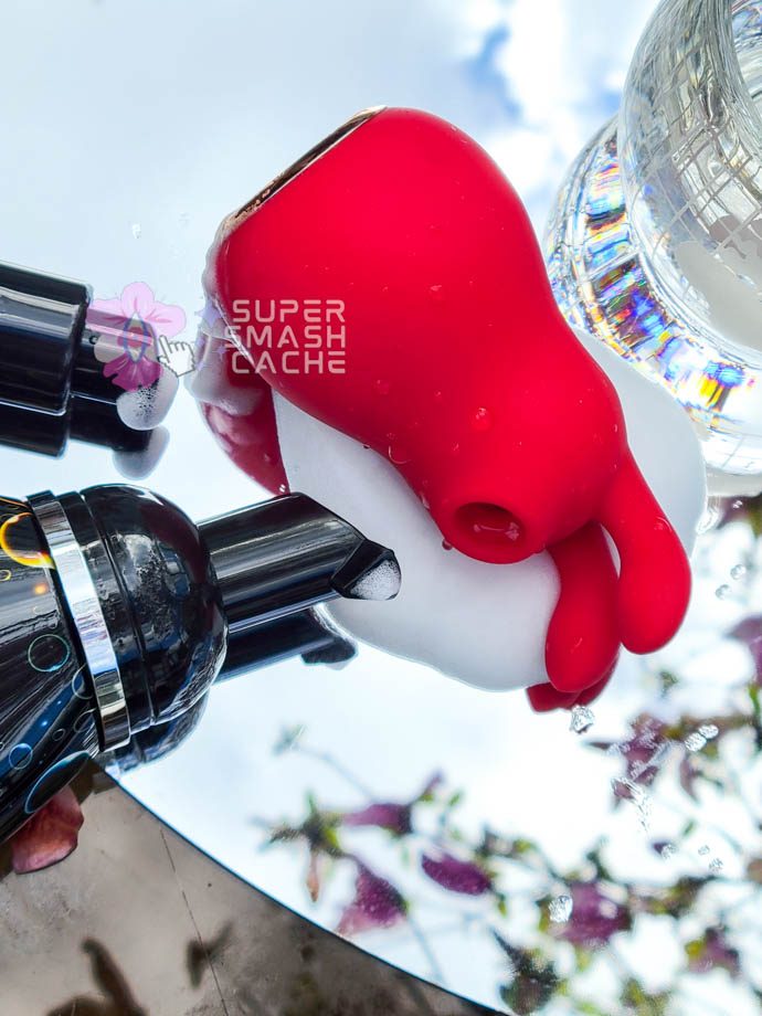 Platinum Hearts’ Bunny Kiss air pulse massager in a puddle of foaming toy cleaner