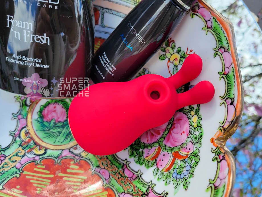 Platinum Hearts’ Bunny Kiss air pulse massager next to toy cleaner and water-based lube