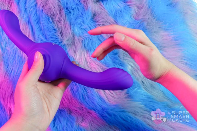 Holding a purple Gyro Vibe thumping vibrator