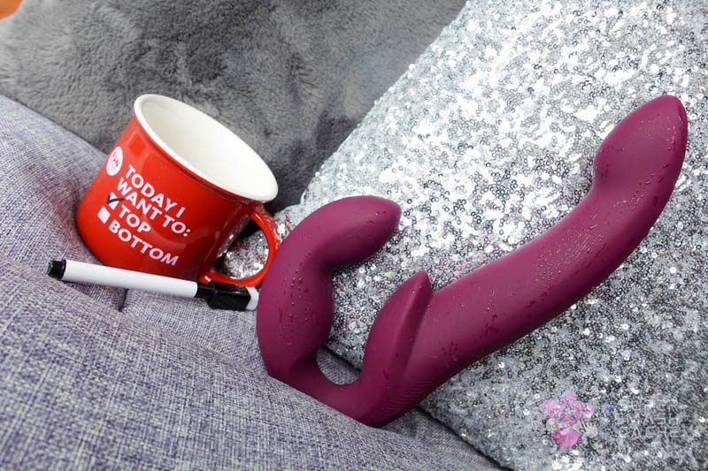 Fun Factory Share Vibe Pro strapless strap-on next to a mug that says, "today I want to top"