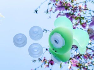 Translucent green Dream Bunny air pulse toy from Pink Punch and suction attachment heads