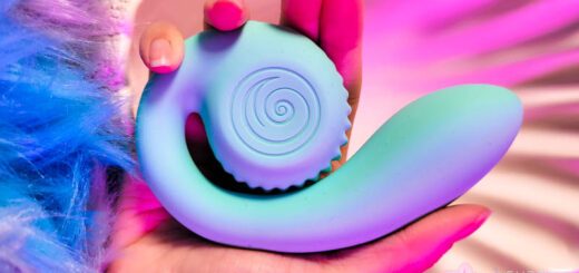 A hand holding a blue Snail Vibe Gizi vibrator