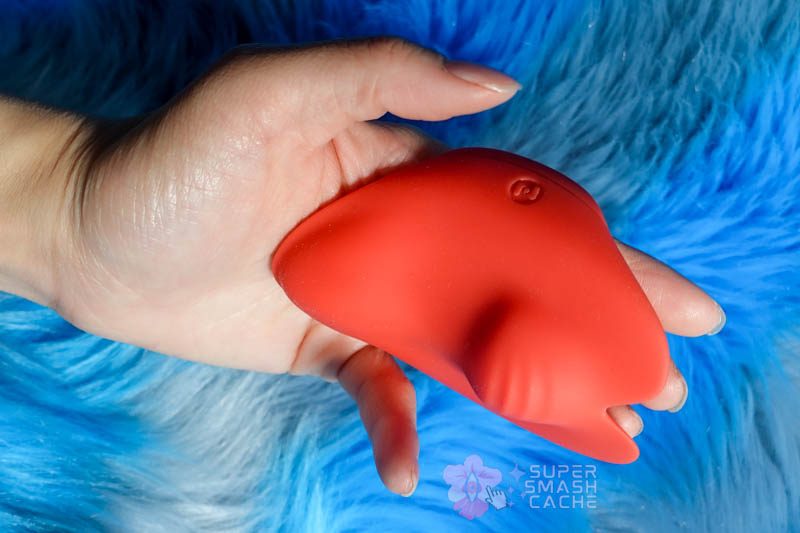 Pockety finger vibrator worn on three fingers on left hand, demonstrating ambidextrous wear and ergonomic fit
