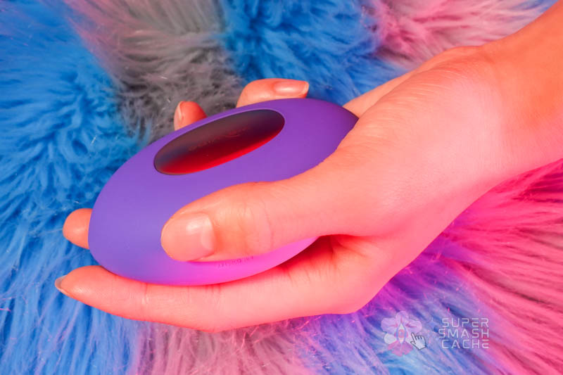 We-Vibe Temp compact vibrator nestled in palm showing ergonomic fit for vulva massage and body teasing